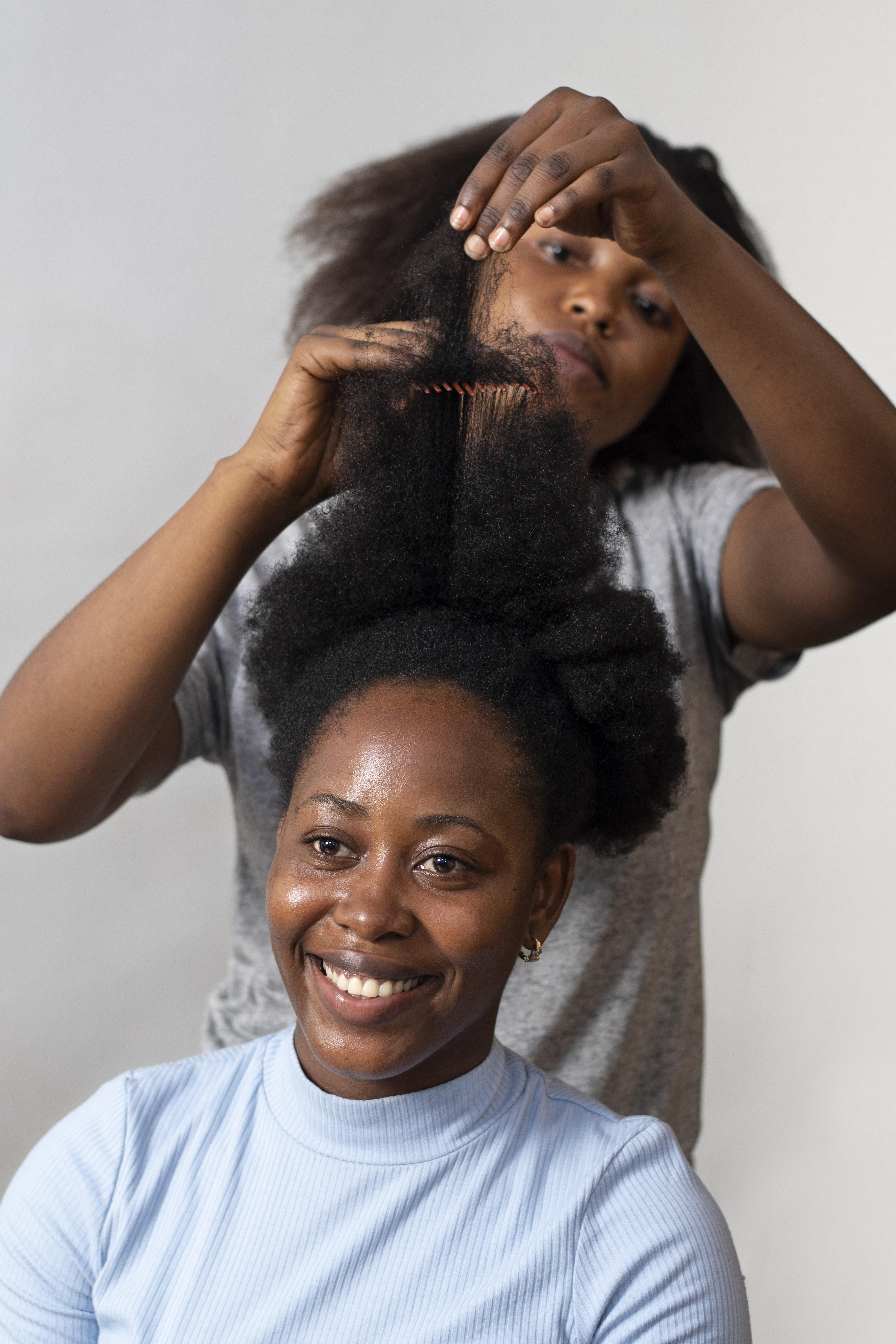 stylist-woman-taking-care-her-client-afro-hair.jpeg